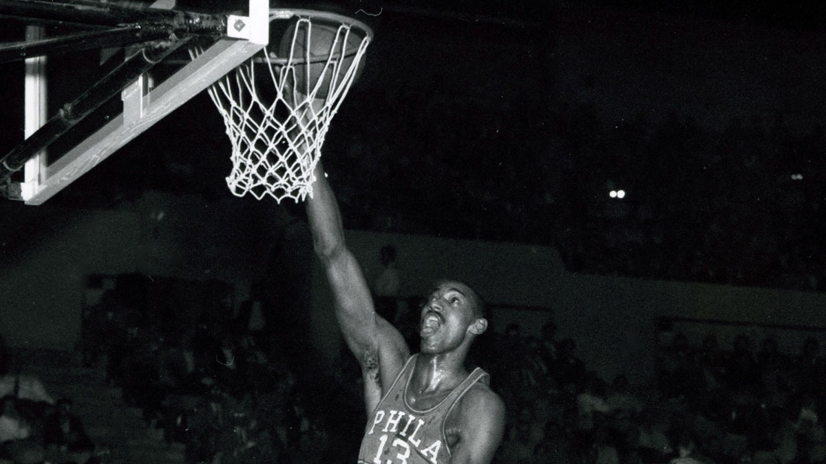 Philadelphia 76ers center Wilt Chamberlain (13) dunks the ball against the Los Angeles Lakers at the Los Angeles Sports Arena.