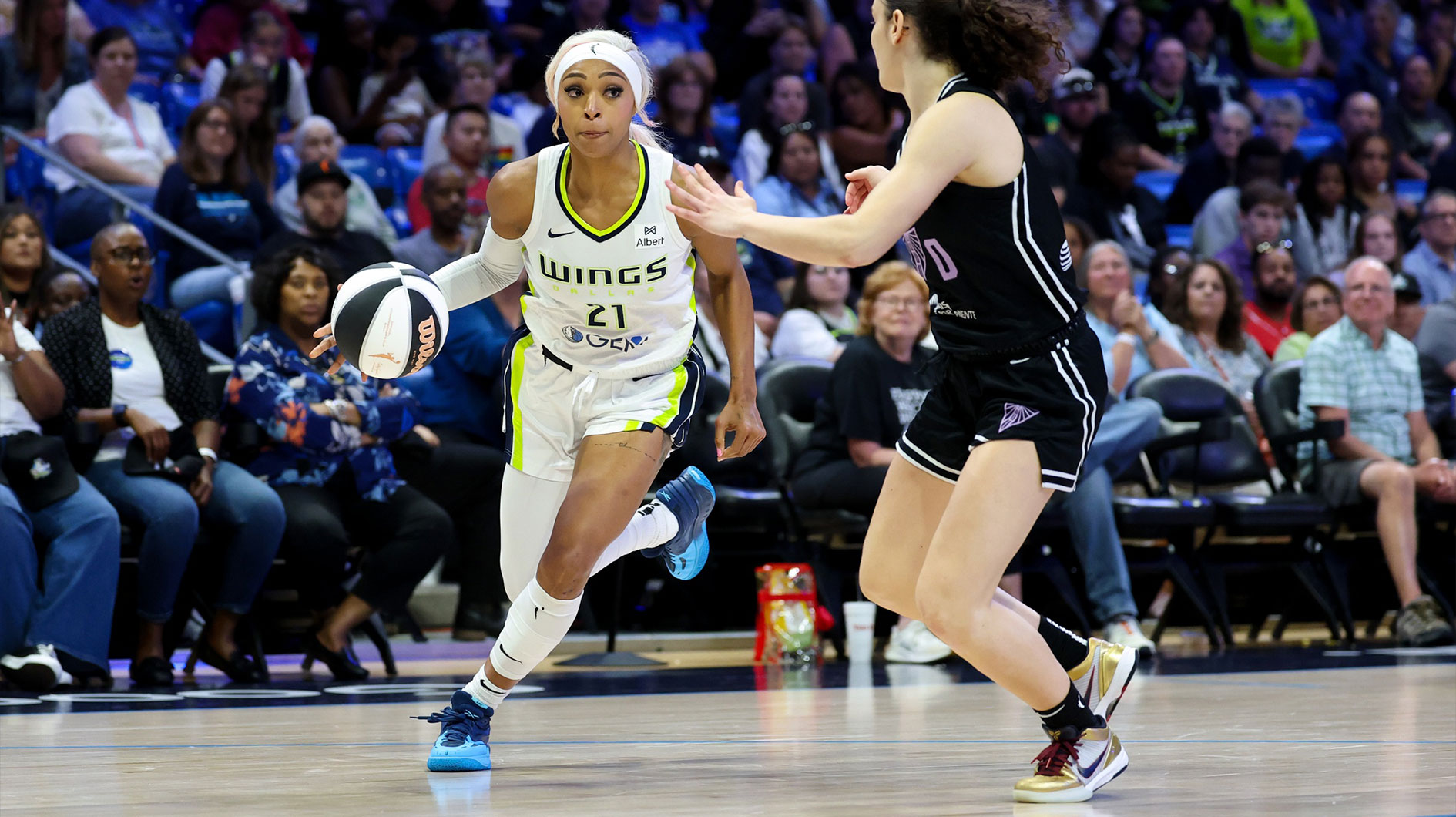 Dallas Wings guard DiJonai Carrington drives to the basket as Golden State Valkyries guard Carla Leite (0) defends during the second half at College Park Center.