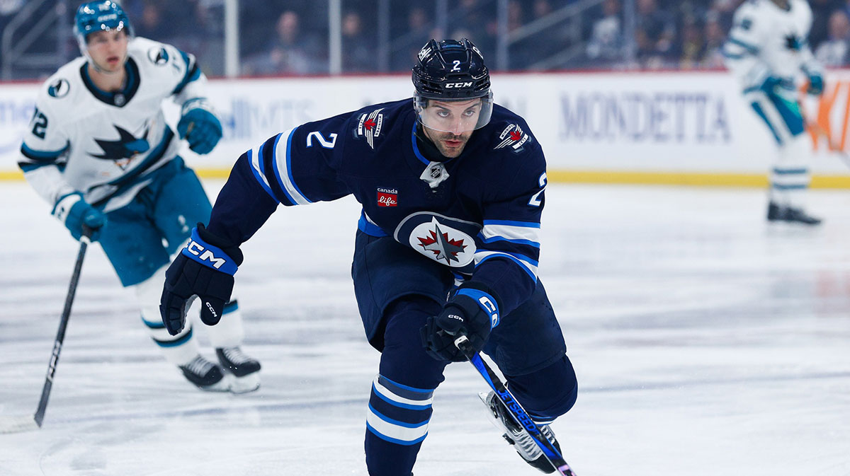 Winnipeg Jets defenseman Dylan DeMelo (2) skates after the puck against the San Jose Sharks during the first period at Canada Life Centre