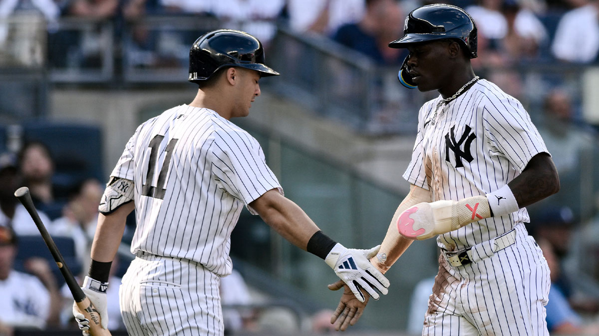 New York Yankees third baseman Jazz Chisholm Jr. (13) is greeted at home plate by New York Yankees shortstop Anthony Volpe (11) after scoring on a RBI single by New York Yankees second baseman Gleyber Torres (not pictured) during the second inning against the Texas Rangers at Yankee Stadium