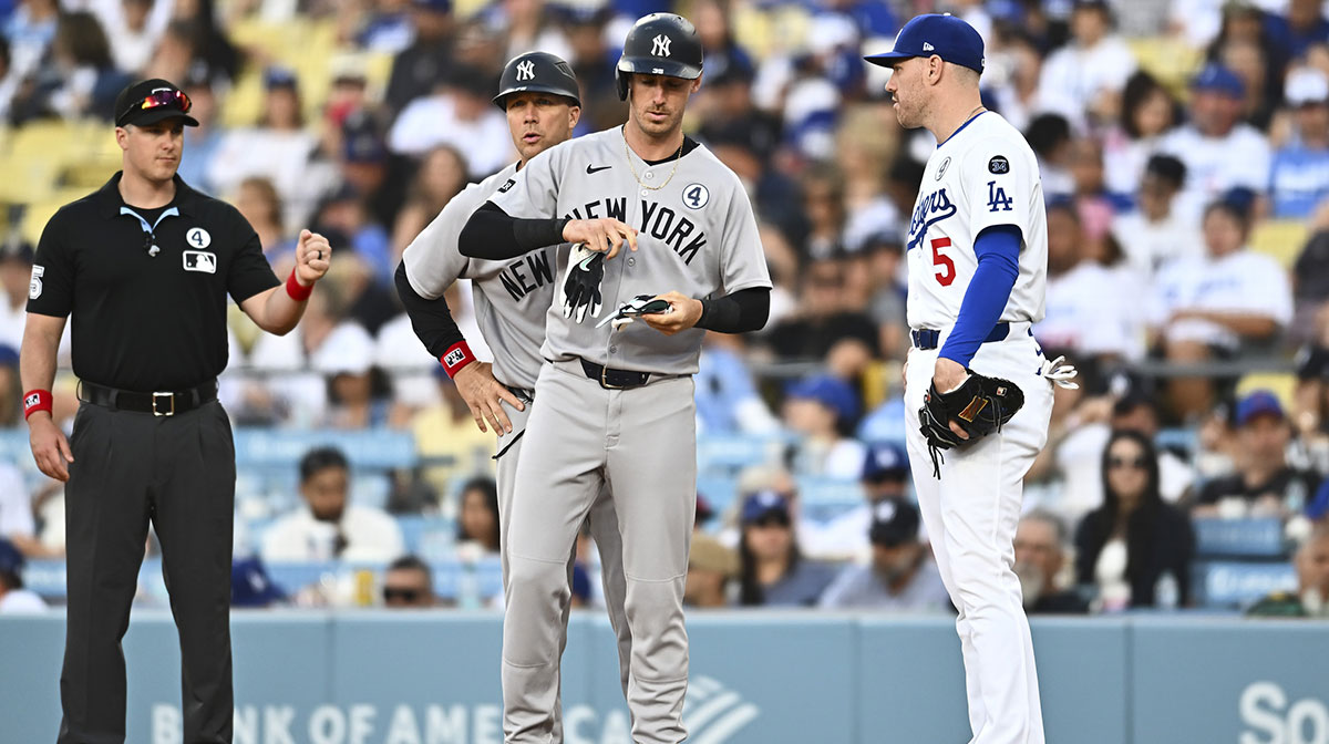 New York Yankees pinch hitter Cody Bellinger (35) walks against Los Angeles Dodgers first baseman Freddie Freeman (5) during the ninth inning at Dodger Stadium.