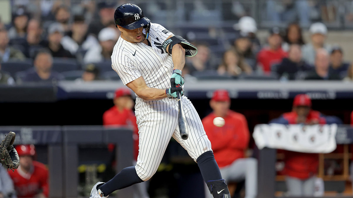 New York Yankees designated hitter Giancarlo Stanton (27) hits a single against the Los Angeles Angels during the fourth inning at Yankee Stadium.