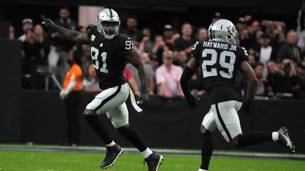 Las Vegas Raiders defensive end Yannick Ngakoue (91) celebrates with cornerback Casey Hayward (29) against the Cincinnati Bengalsin the first half at Allegiant Stadium.