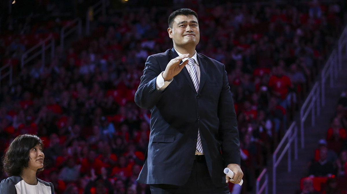 Former Houston Rockets Yao Ming waves to the crowd during a ceremony to retire his jersey during a game against the Chicago Bulls at Toyota Center.