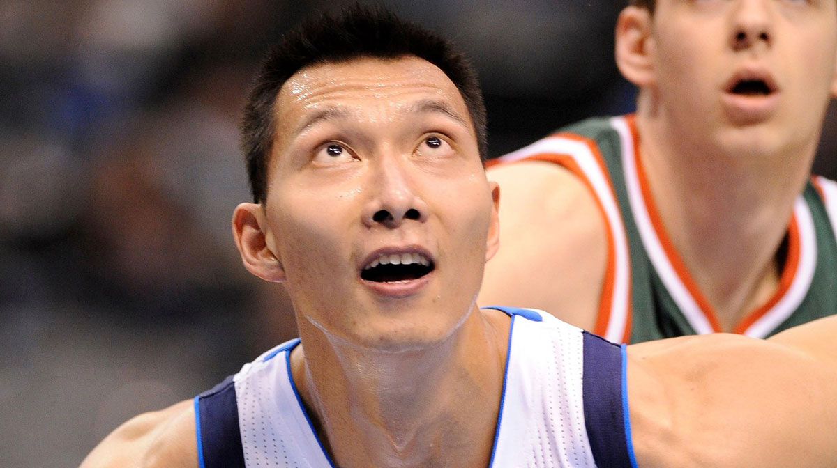 Dallas Mavericks power forward Yi Jianlian (9) fights for the rebound in front of Milwaukee Bucks forward Jon Leuer (30) during the fourth quarter at the American Airlines Center. The Mavericks defeated the Bucks 102-76.