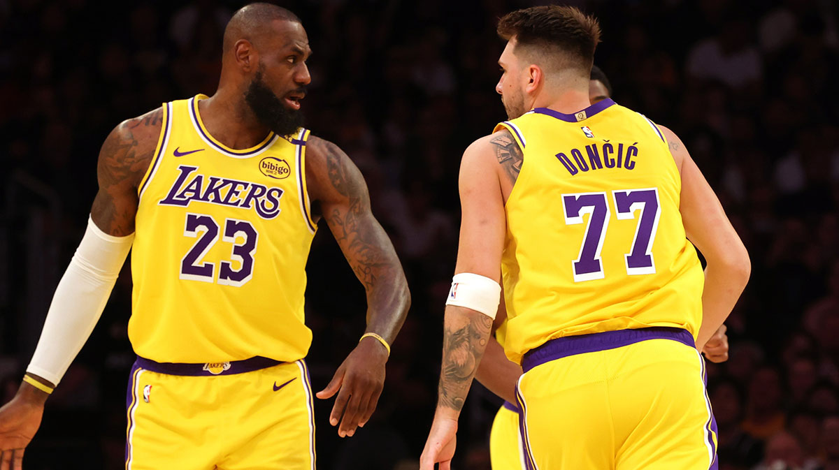 Los Angeles Lakers forward LeBron James (23) and guard Luka Doncic (77) react after a play during the first quarter against the Minnesota Timberwolves.