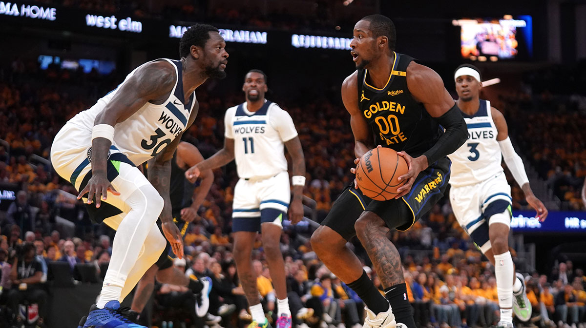 Golden State Warriors forward Jonathan Kuminga (00) holds onto the ball next to Minnesota Timberwolves forward Julius Randle (30) in the third quarter during game four of the second round for the 2025 NBA Playoffs at Chase Center.