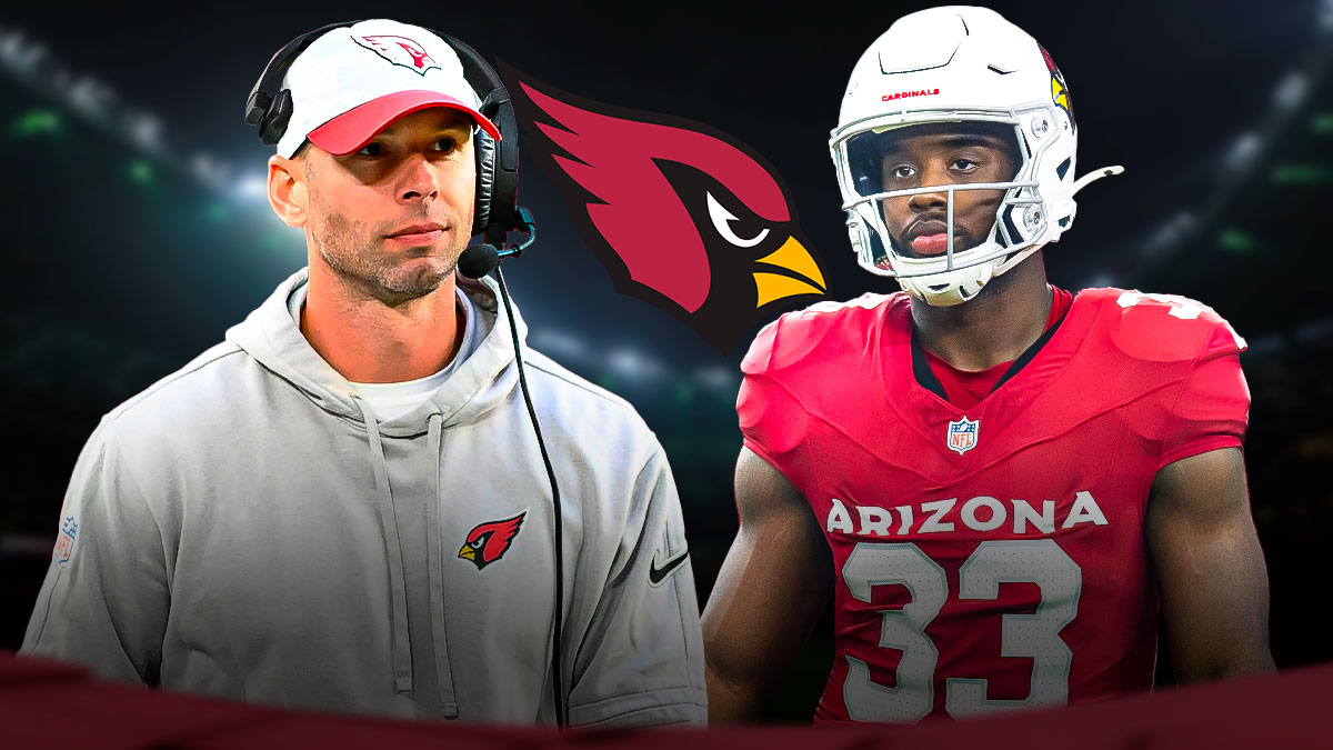 Cardinals HC Jonathan Gannon with Cardinals RB Trey Benson. Arizona Cardinals logo in background