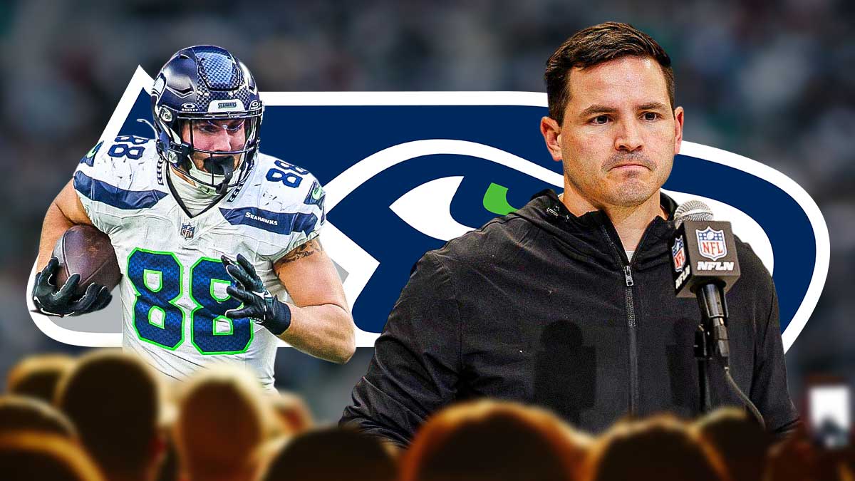 Seahawks coach Mike Macdonald with Seahawks TE AJ Barner. Seattle Seahawks logo in background