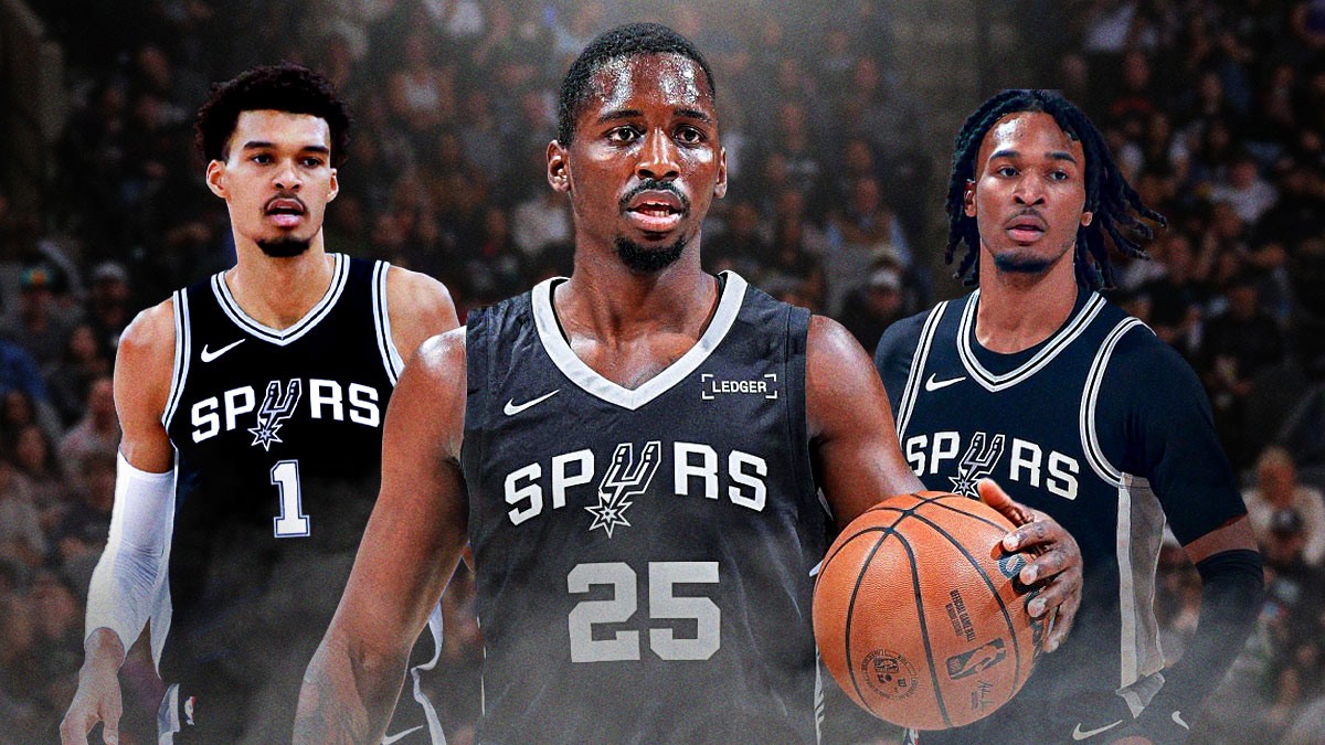 David Jones García wearing a San Antonio Spurs jersey in the middle, Victor Wembanyama and Stephon Castle around him