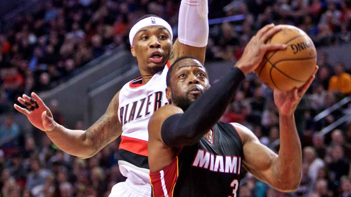 Miami Heat guard Dwyane Wade (3) shoots over Portland Trail Blazers guard Damian Lillard (0) during the second quarter at the Moda Center.