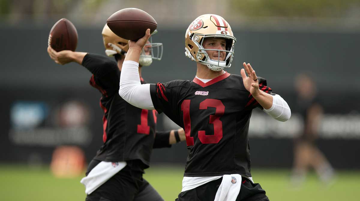 San Francisco 49ers quarterbacks Tanner Mordecai (14) and Brock Purdy (13) throw during a passing drill on the second day of training camp.