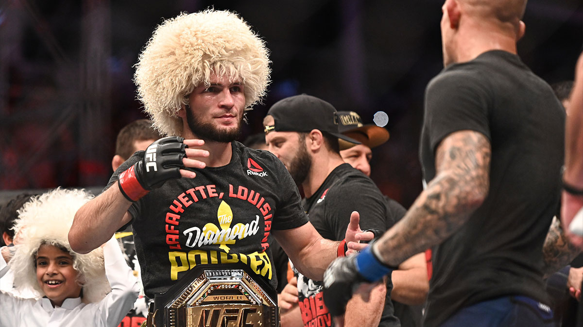 Khabib Nurmagomedov (red gloves) greets Dustin Poirier (blue gloves) during UFC 242 at The Arena.