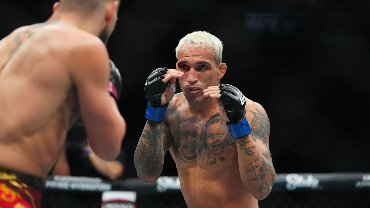 Ilia Topuria (red gloves) fights Charles Oliveira (blue gloves) during UFC 317 at T-Mobile Arena.