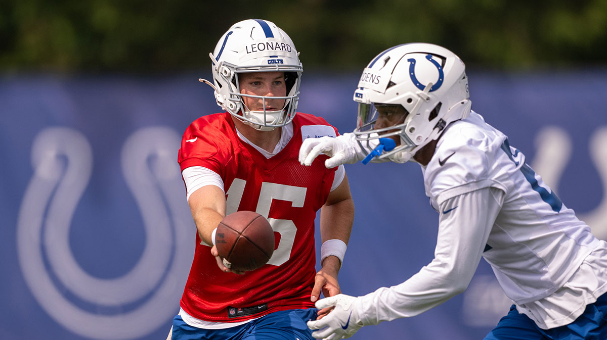 Indianapolis Colts quarterback Riley Leonard (15) hands the ball off during training camp at the Farm Bureau Football complex.