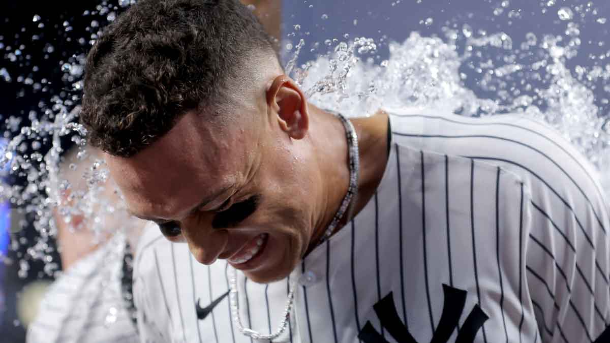 New York Yankees designated hitter Aaron Judge (99) is doused with water after his tenth inning walkoff sacrifice fly against the Seattle Mariners at Yankee Stadium.