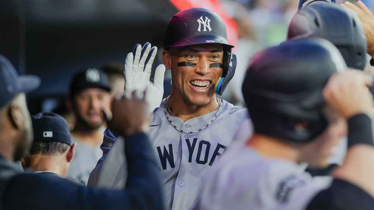 New York Yankees outfielder Aaron Judge (99) celebrates after scoring against the Toronto Blue Jays with teammates during the fifth inning at Rogers Centre.
