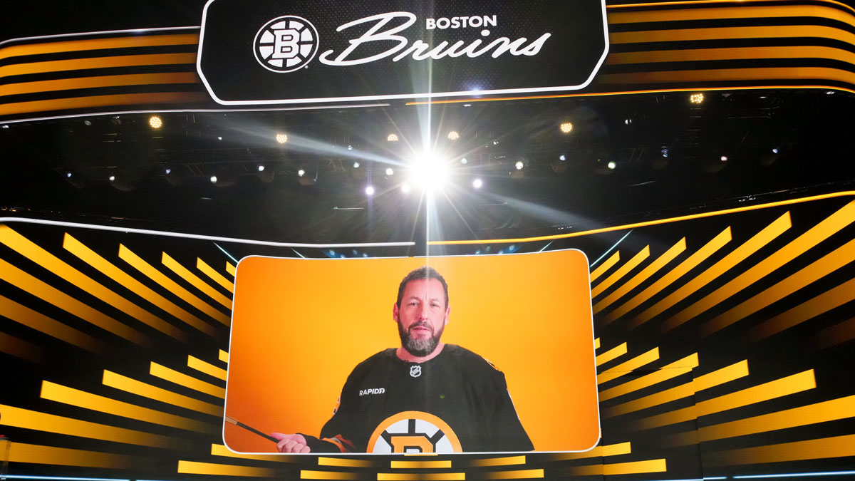 Adam Sandler announces the seventh overall pick for the Boston Bruins in the first round of the 2025 NHL Draft at Peacock Theater.