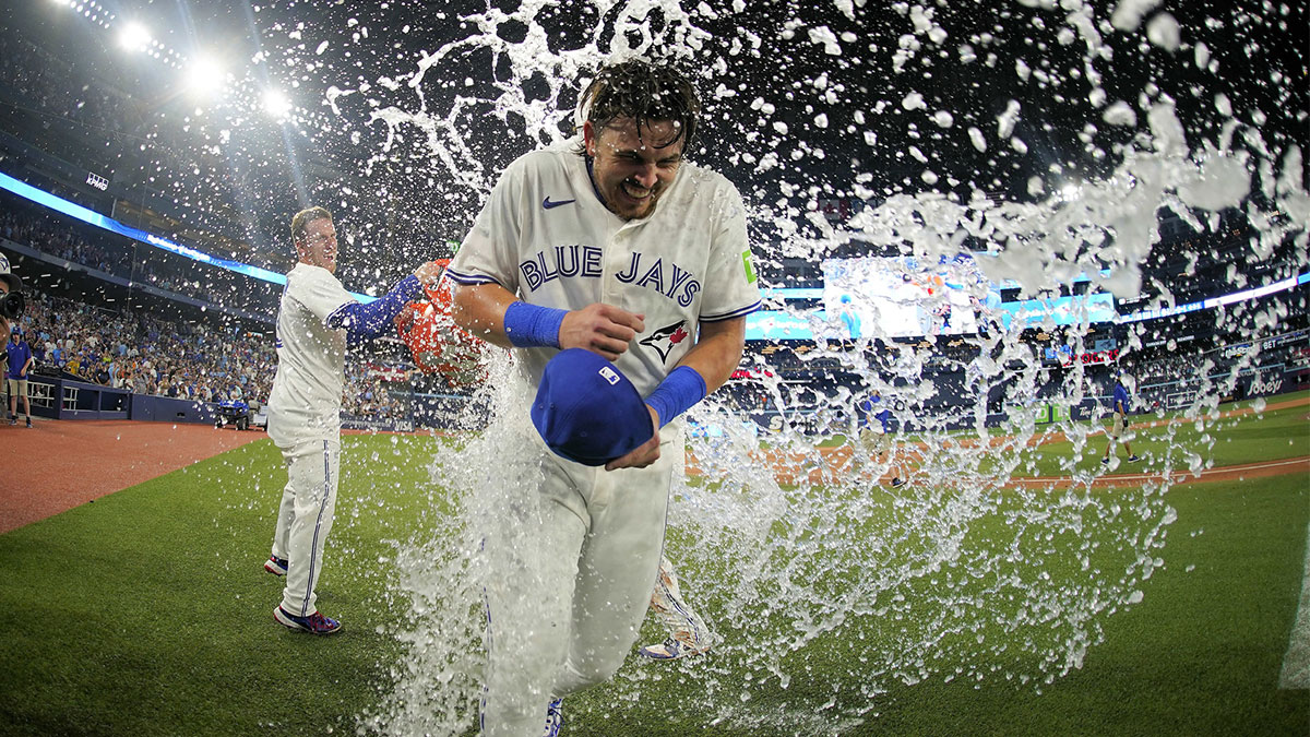 Jul 5, 2025; Toronto, Ontario, CAN; Toronto Blue Jays center fielder Myles Straw (3) throws ice water onto right fielder Addison Barger (47) after a win over the Los Angeles Angels in the 11th inning at Rogers Centre. Mandatory Credit: John E. Sokolowski-Imagn Images