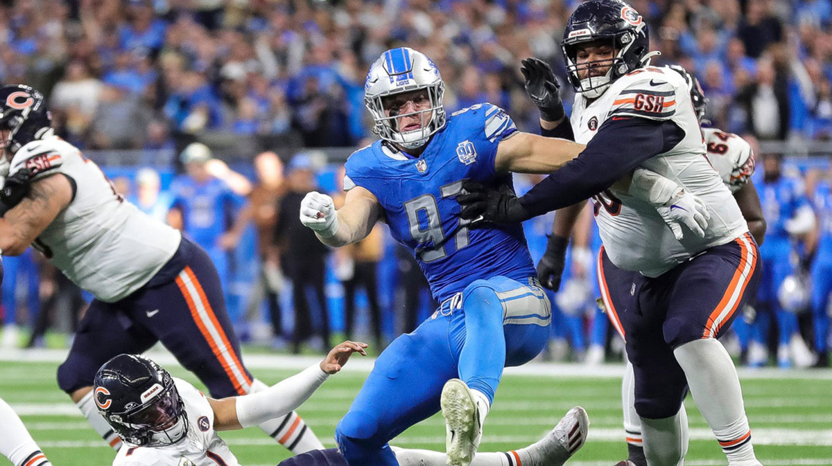 Detroit Lions defensive end Aidan Hutchinson (97) and Chicago Bears offensive tackle Darnell Wright (58) battle for the ball after Chicago Bears quarterback Justin Fields (1) is forced to fumble by Hutchinson during the second half at Ford Field in Detroit on Sunday, Nov. 19, 2023.