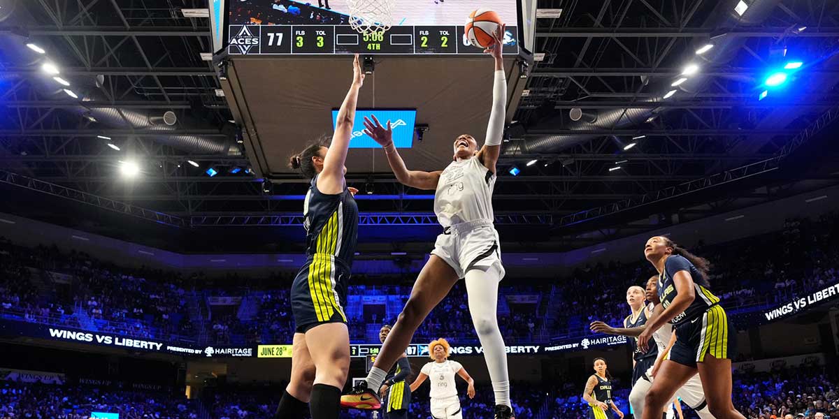 Las Vegas Aces center A'ja Wilson (22) scores a layup against Dallas Wings center Li Yueru (28) during the second half at College Park Center.