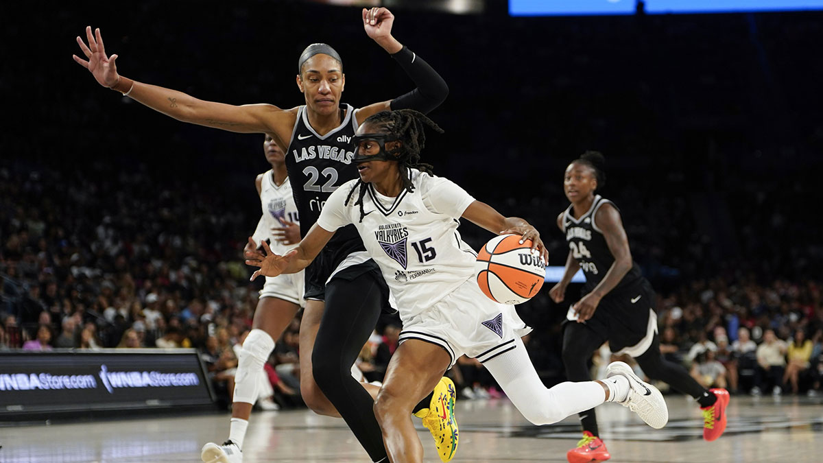 Golden State Valkyries guard Tiffany Hayes (15) drives the ball past Las Vegas Aces center A'ja Wilson (22) during the second half of a WNBA basketball game at Michelob Ultra Arena.