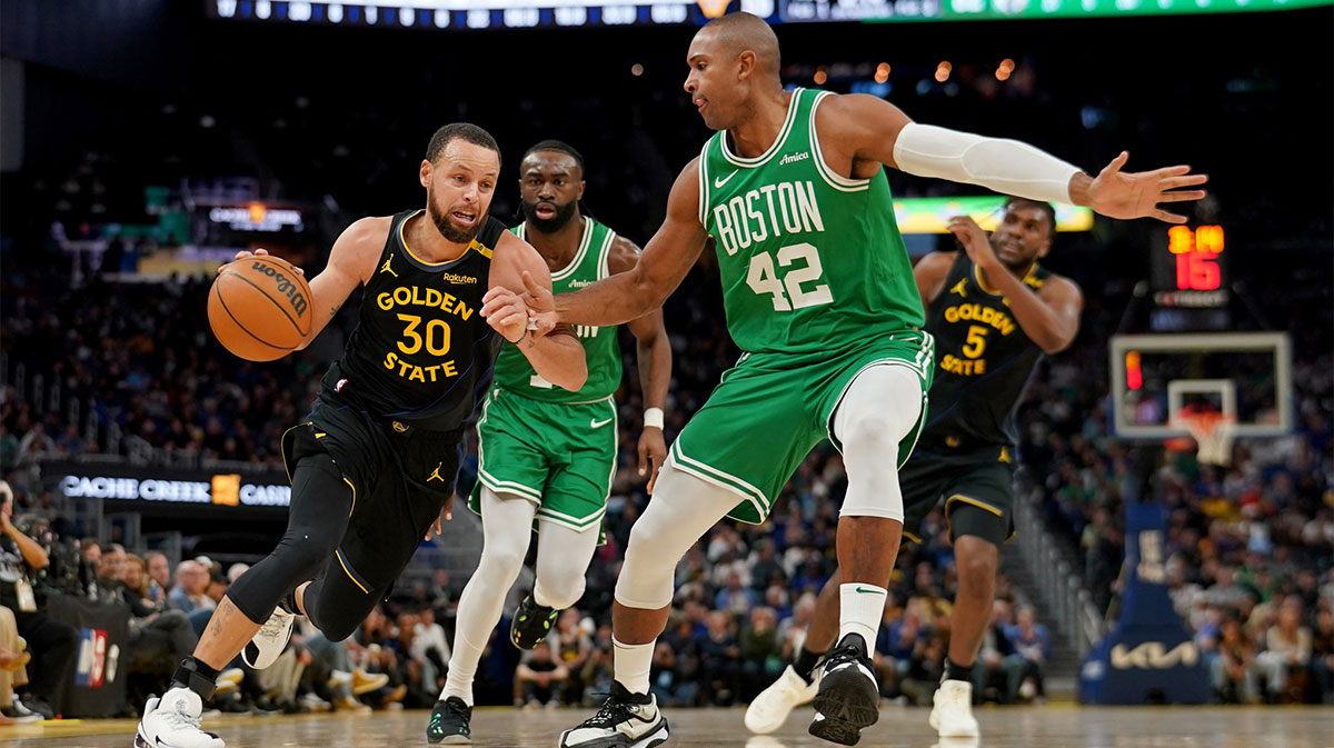 Golden State Warriors guard Stephen Curry (30) dribbles the ball next to Boston Celtics center Al Horford (42) in the third quarter at the Chase Center.