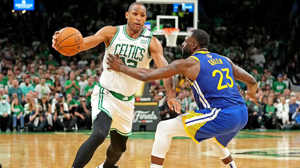 Boston Celtics center Al Horford (42) drives to the basket against Golden State Warriors forward Draymond Green (23) during the fourth quarter in game six of the 2022 NBA Finals at TD Garden.