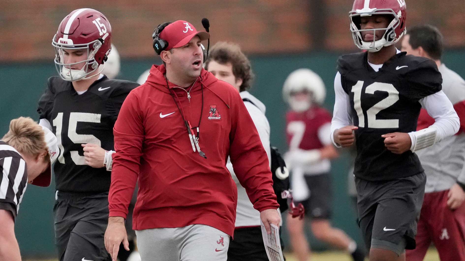 Quarterbacks coach Nick Seridan walks between quarterbacks Ty Simpson (15) and Keelon Russell (12)during Spring Practice for the Crimson Tide.