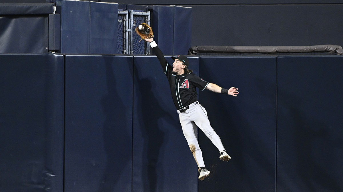 Arizona Diamondbacks center fielder Alek Thomas (5) makes a leaping catch on a ball hit by San Diego Padres right fielder Fernando Tatis Jr. (23) during the eighth inning at Petco Park.