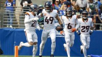 Denver Broncos linebacker Alex Singleton (49) celebrates with cornerback Riley Moss (21), safety P.J. Locke (6) and cornerback Ja'Quan McMillian (29) after intercepting a pass against the Seattle Seahawks during the first quarter at Lumen Field.