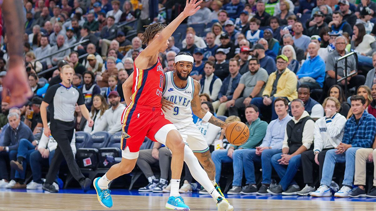 Minnesota Timberwolves guard Nickeil Alexander-Walker (9) dribbles against the New Orleans Pelicans guard Dyson Daniels (11) in the first quarter at Target Center.