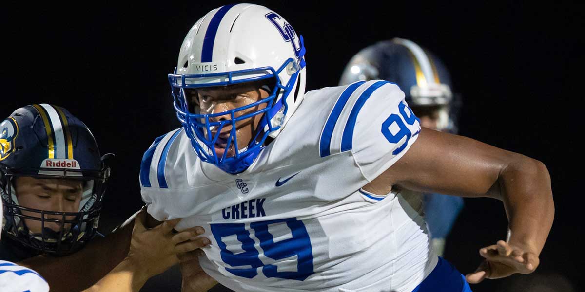 Cedar Creek Eagles defensive lineman Alfred Collins rushes across the line against the Akin Eagles during the third quarter at the non-district football game on Sept. 5, 2019, at the Toney Burger Stadium.