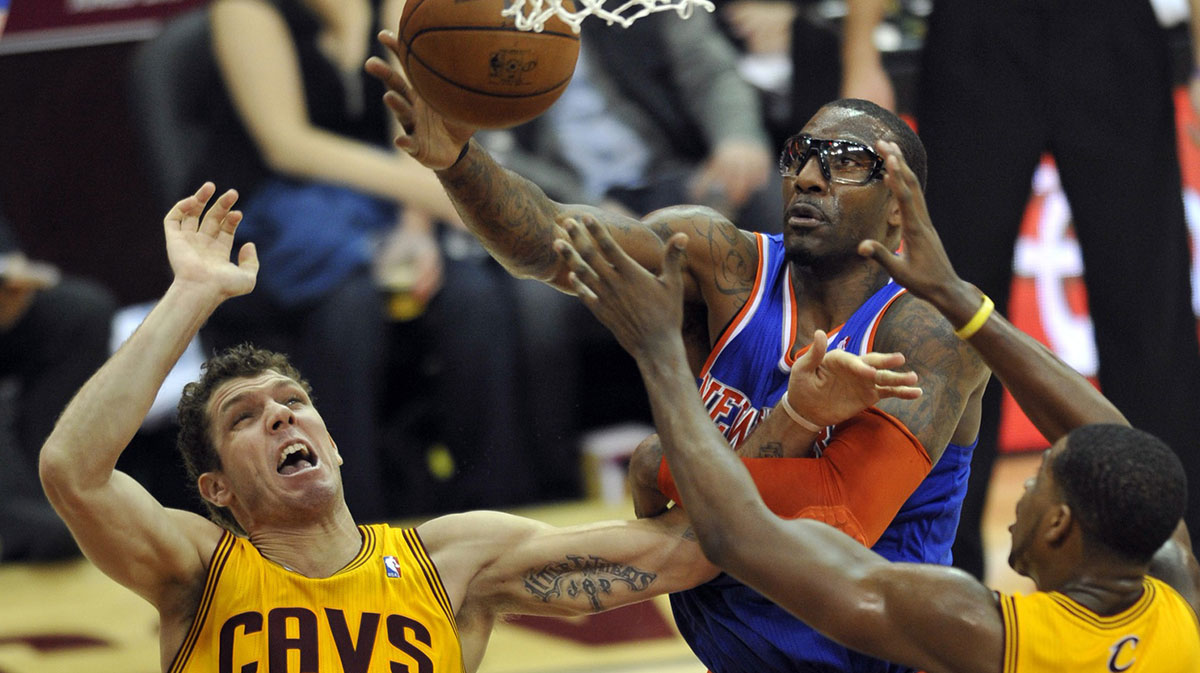 New York Knicks power forward Amar'e Stoudemire (center) grabs a rebound between Cleveland Cavaliers small forward Luke Walton (left) and power forward Tristan Thompson (13) in the third quarter at Quicken Loans Arena.