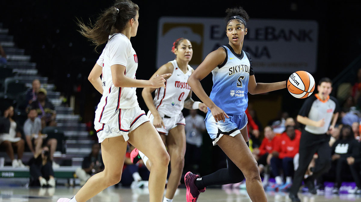 Chicago Sky forward Angel Reese (5) drives past Washington Mystics guard Sonia Citron (22) and Washington Mystics forward Shakira Austin (0) during the second half at EagleBank Arena.