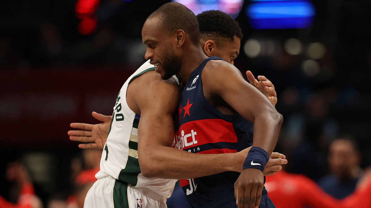 Former teammates Milwaukee Bucks forward Giannis Antetokounmpo (34) and Washington Wizards forward Khris Middleton (32) hug prior to their game at Capital One Arena.