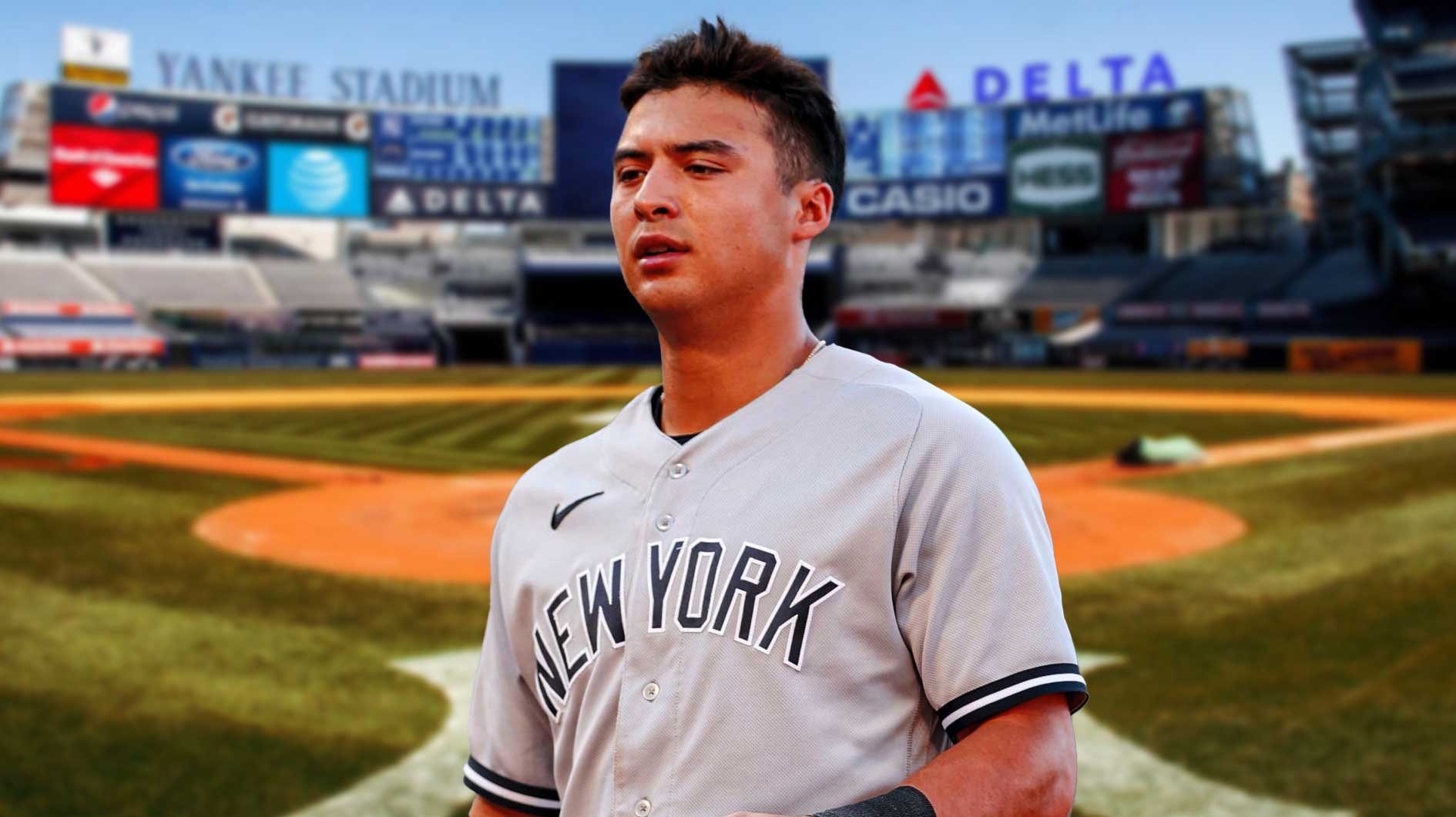 Yankees Anthony Volpe looking down/upset with Yankee Stadium in background.