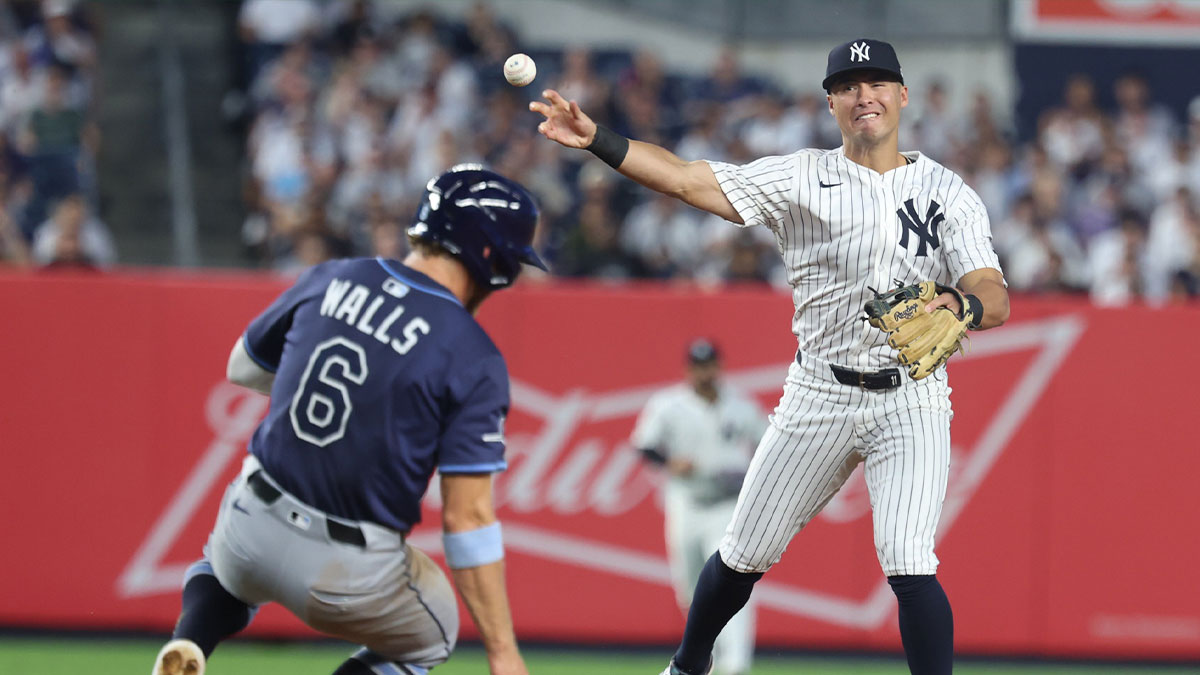 New York Yankees shortstop Anthony Volpe (11) forces out Tampa Bay Rays shortstop Taylor Walls (6) at second base and throws to first to complete the double play on a ball hit by center fielder Chandler Simpson (not pictured) at Yankee Stadium