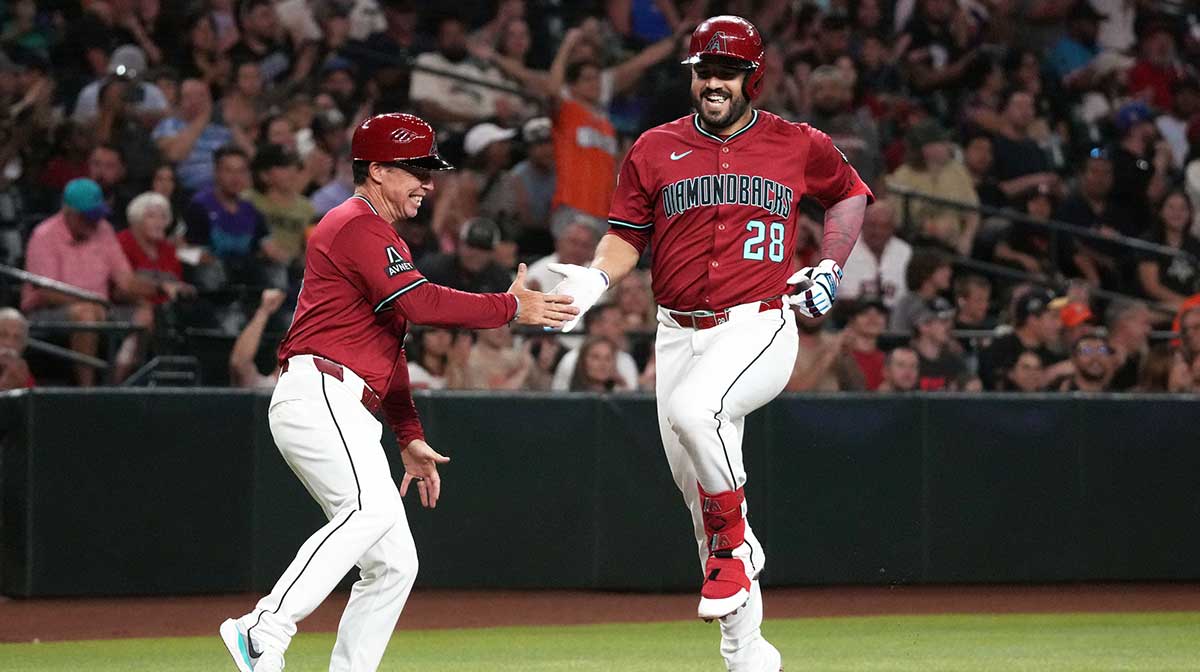 Arizona Diamondbacks third base Eugenio Suarez (28) celebrates with third base coach Shaun Larkin (88) after hitting a home run against the Houston Astros in the third inning at Chase Field. MLB