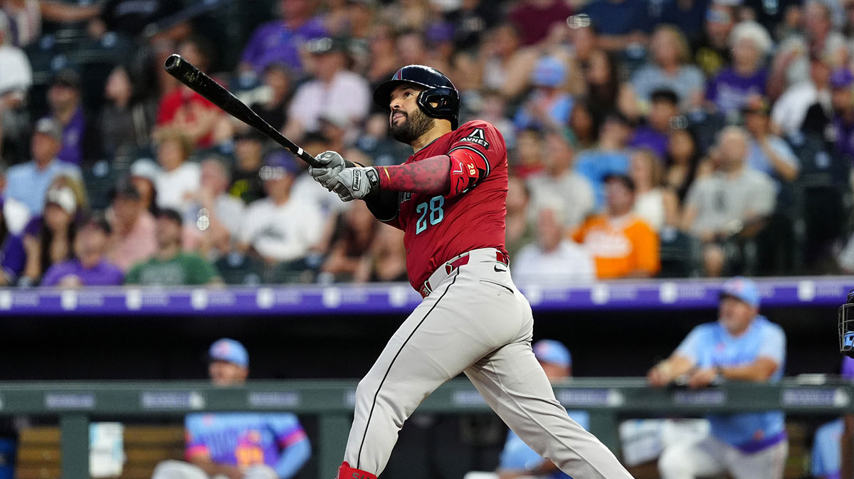 Arizona Diamondbacks third baseman Eugenio Suarez (28) hits a two run home run in the sixth inning against the Colorado Rockies at Coors Field. Mandatory Credit: Ron Chenoy-Imagn Images