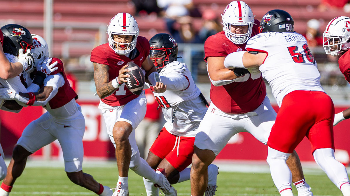 Stanford Cardinal quarterback Ashton Daniels (14) is chased down from behind during the first quarter against the Louisville Cardinals at Stanford Stadium.