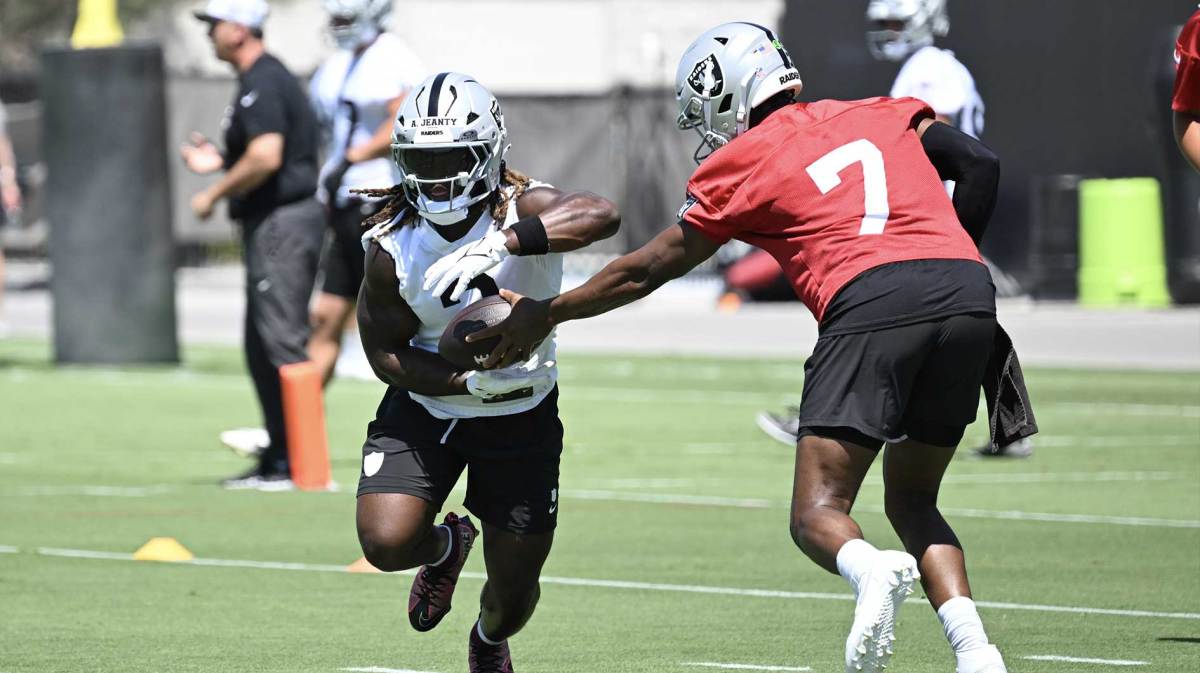 Las Vegas Raiders quarterback Geno Smith (7) hands the ball off to running back Ashton Jeanty (2) during Las Vegas Raiders Minicamp at Intermountain Health Performance Center.