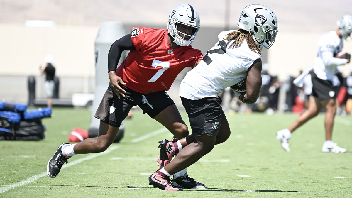 Las Vegas Raiders quarterback Geno Smith (7) hands the ball to running back Ashton Jeanty (2) during Las Vegas Raiders Minicamp at Intermountain Health Performance Center.