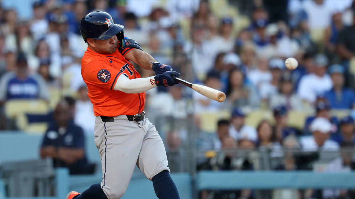 Houston Astros second baseman Jose Altuve (27) hits a triple during the eighth inning against the Los Angeles Dodgers at Dodger Stadium.