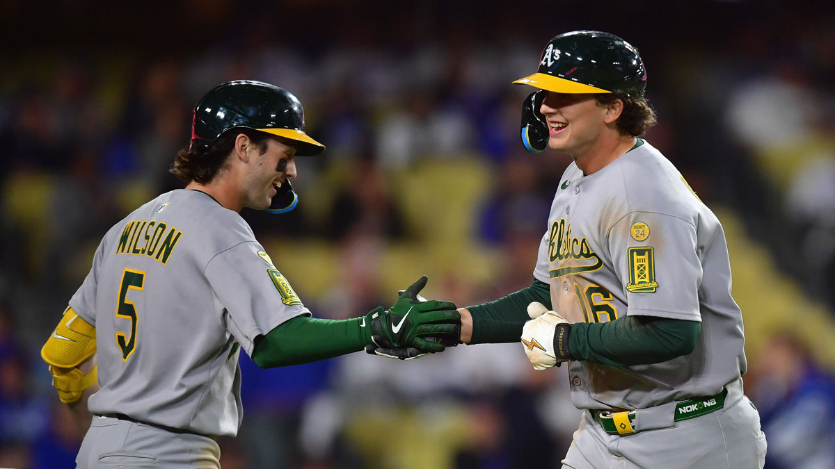 Athletics first baseman Nick Kurtz (16) is greeted by shortstop Jacob Wilson (5) after hitting a solo home run against the Los Angeles Dodgers during the eighth inning at Dodger Stadium. 