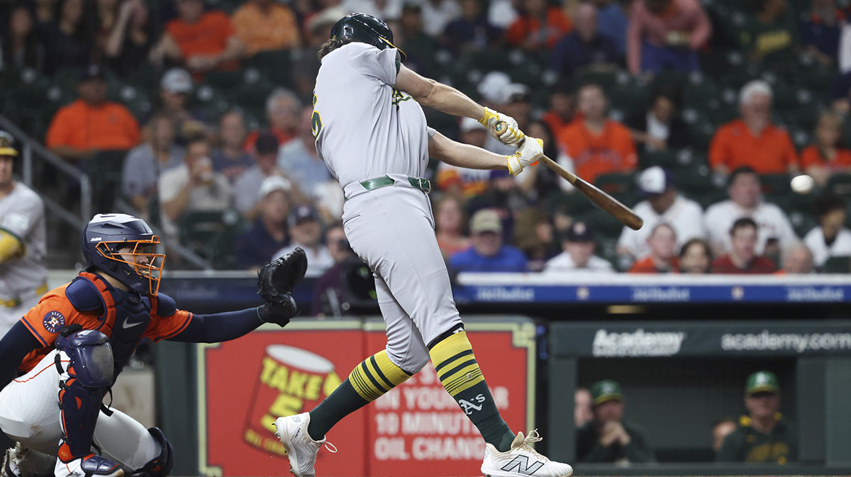 Athletics designated hitter Nick Kurtz (16) hits a single during the first inning against the Houston Astros at Daikin Park.
