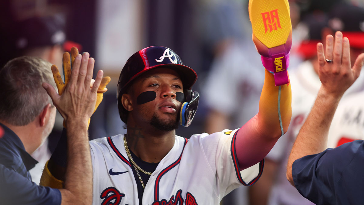 Atlanta Braves right fielder Ronald Acuna Jr. (13) celebrates with teammates after scoring a run against the New York Mets in the fifth inning at Truist Park.