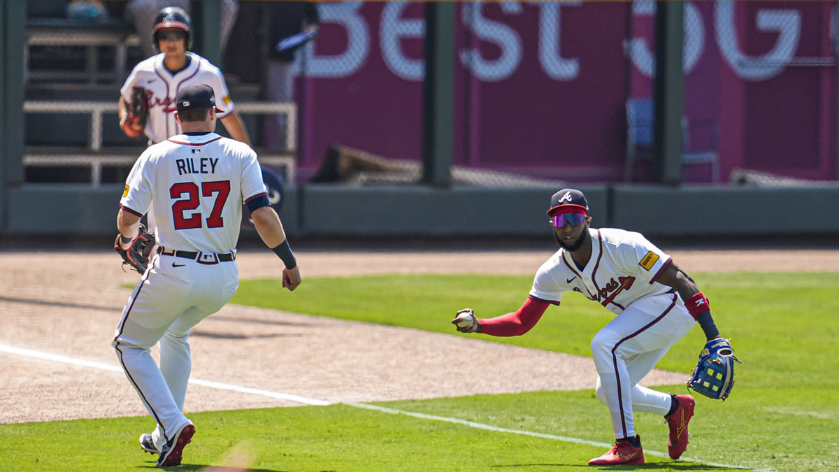 A ball hit by Baltimore Orioles second baseman Jackson Holliday (7) (not pictured) drops for a hit between Atlanta Braves third baseman Austin Riley (27) and left fielder Jurickson Profar (7) during the first inning at Truist Park.