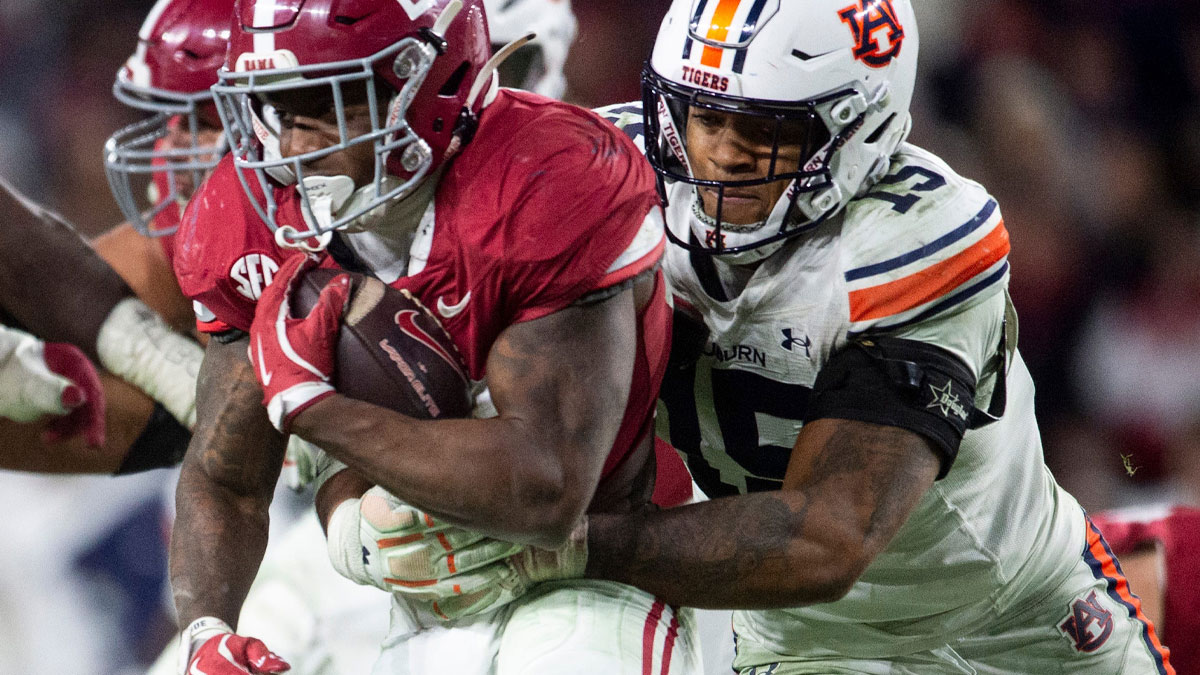 Auburn Tigers defensive lineman Keldric Faulk (15) takes down Alabama Crimson Tide running back Jam Miller (26) as Auburn Tigers take on Alabama Crimson Tide at Bryant-Denny Stadium