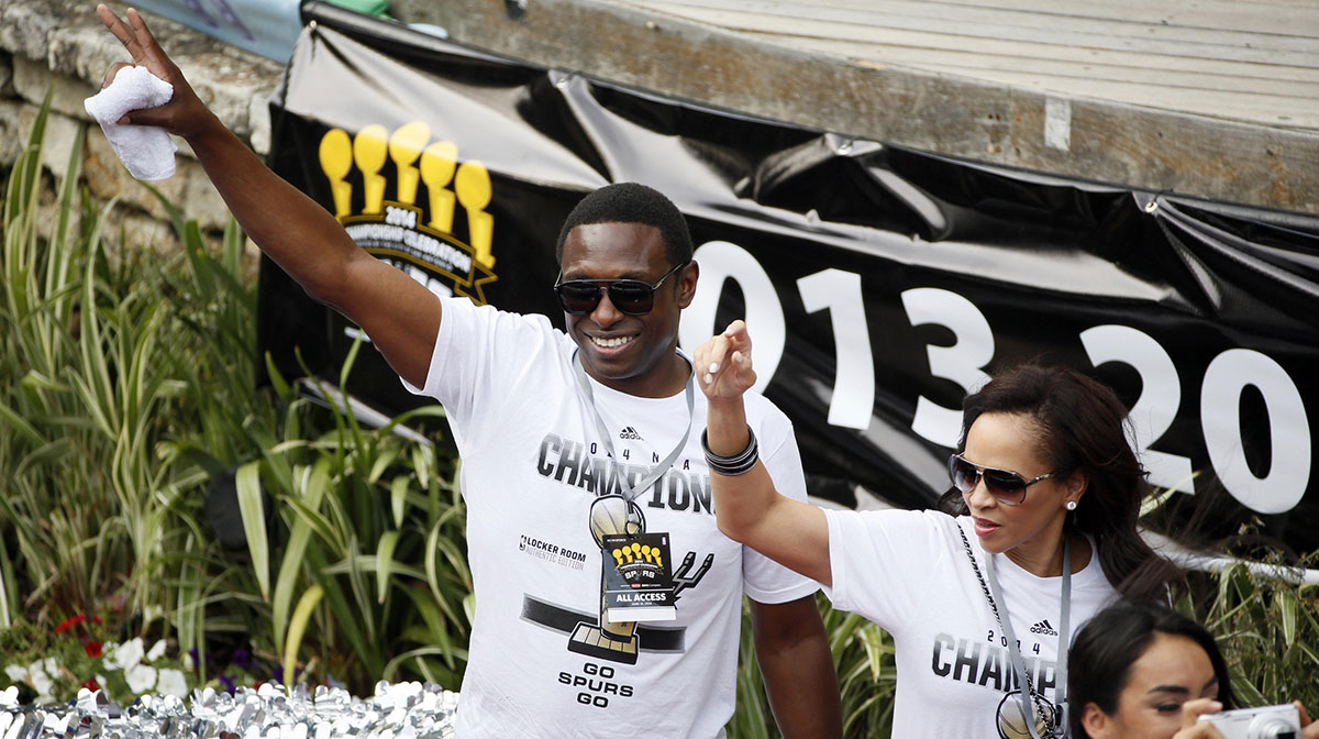 San Antonio Spurs former guard Avery Johnson waves to the fans during the NBA championship parade at San Antonio River Walk.